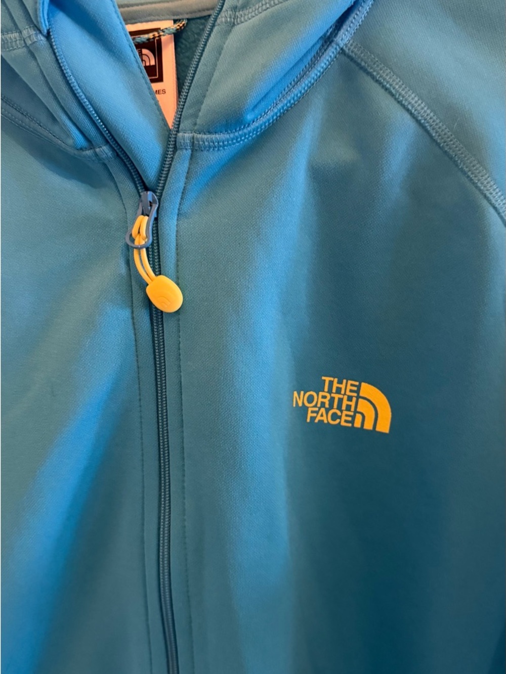 The North Face Turquoise Zip-Up Hoodie with Yellow Logo